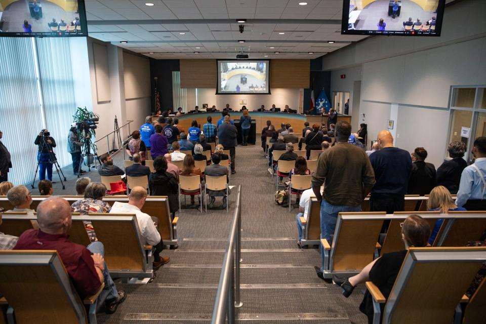 City council attendees stand to support a public commenter speaking against the Inner Harbor Desalination Plant plans on Tuesday, Jan. 23, 2023, in Corpus Christi, Texas.