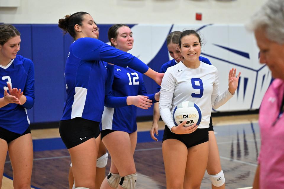 Lake Worth Christian's Sarah Montero accepts the game ball as her teammates congratulate her for eclipsing 1,000 digs in her volleyball career at Lake Worth Christian (Sept. 5, 2023).