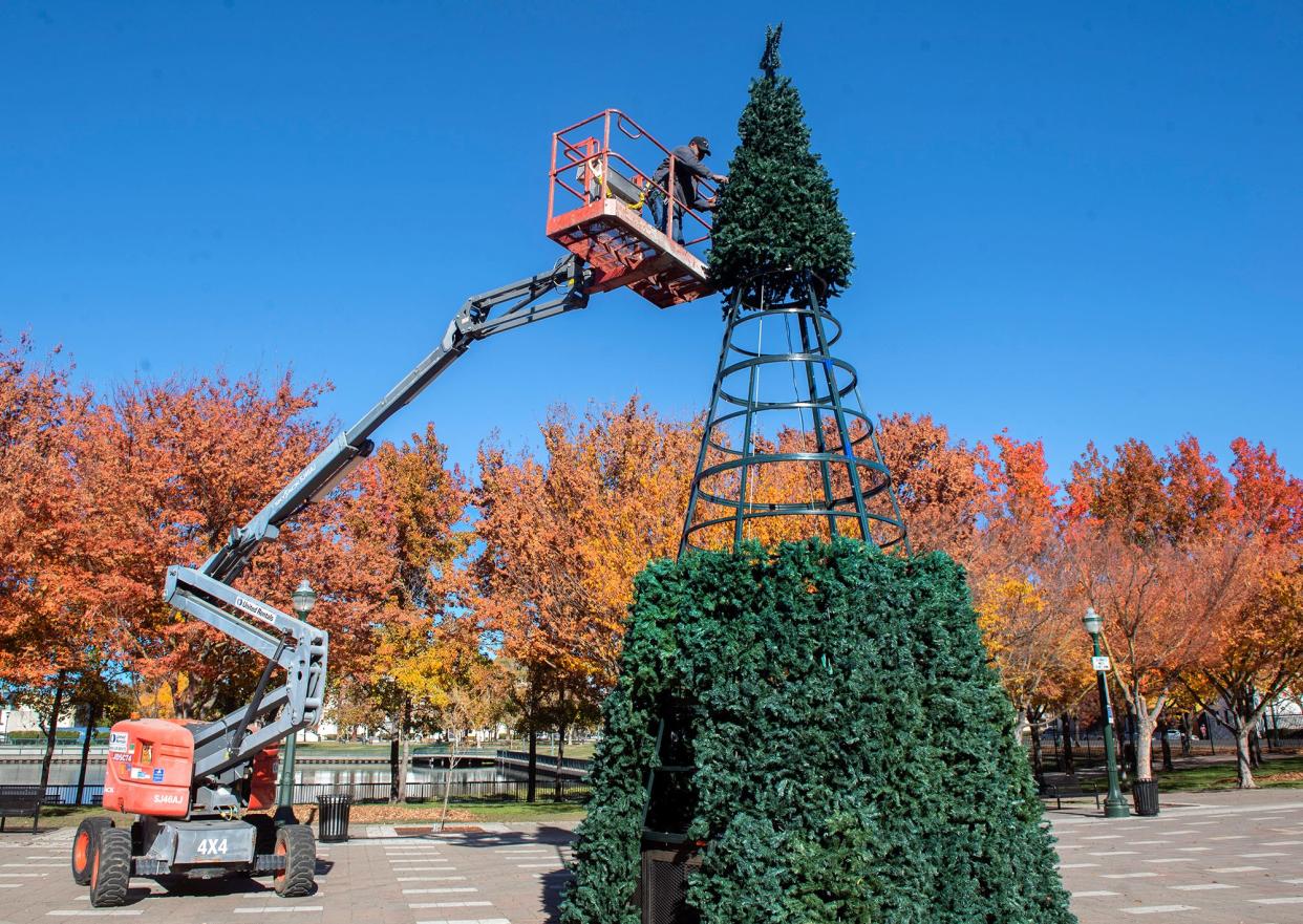 City of Stockton public works employee Jose Flores works with a crew assembling the city Christmas tree at the Weber Point Events Center in downtown Stockton on Tuesday, Nov. 29, 2022. The crew was preparing for the annual tree lighting ceremony at about 5:30 p.m. on Saturday, Dec. 3 followed by the Lynn Hahn Memorial Delta Reflections Lighted Boat Parade at about 6 p.m. Preceding the ceremony will be the Stockton Holiday Parade at 3 p.m.