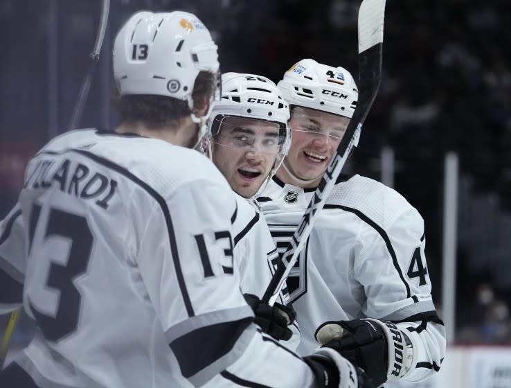 Los Angeles Kings defenseman Sean Walker (26) celebrates a goal with teammates Gabriel Vilardi (13) and Drake Rymsha (43) against the Colorado Avalanche during the first period of an NHL hockey game Thursday, May, 13, 2021, in Denver. (AP Photo/Jack Dempsey)