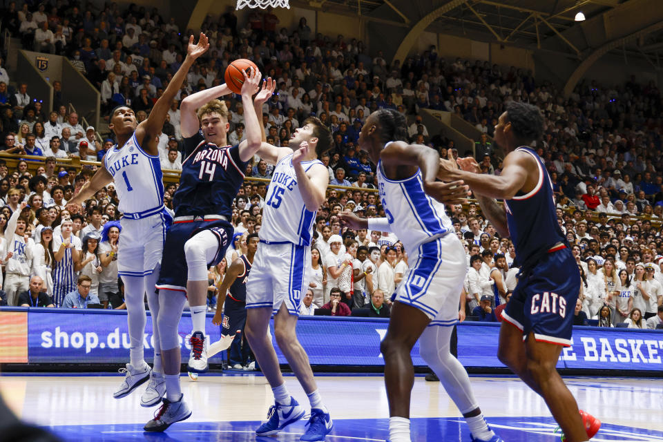 Arizona center Motiejus Krivas (14) tries to shoot between Duke guard Caleb Foster (1) and center Ryan Young (15) during the first half of an NCAA college basketball game in Durham, N.C., Friday, Nov. 10, 2023. (AP Photo/Nell Redmond)