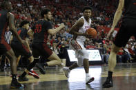 UNLV's Bryce Hamilton (13) drive against San Diego State's Jordan Schakel (20) during the first half of an NCAA college basketball game on Sunday, Dec. 26, 2020, in Las Vegas. (AP Photo/Joe Buglewicz)