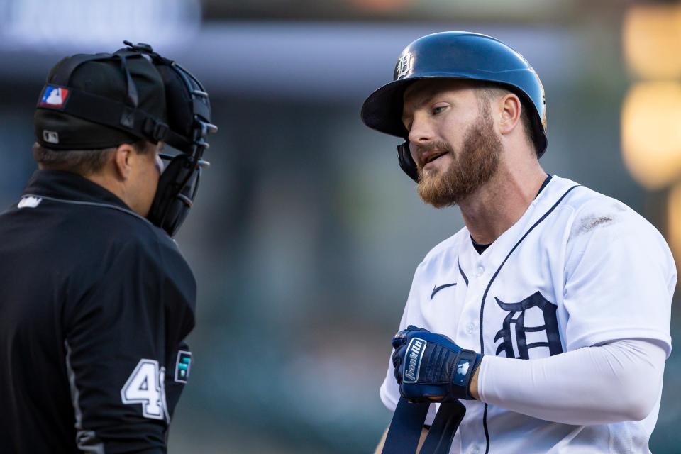 Tigers left fielder Robbie Grossman talks with umpire Nick Mahrley after a called strike during the third inning on Monday, May 9, 2022, at Comerica Park.