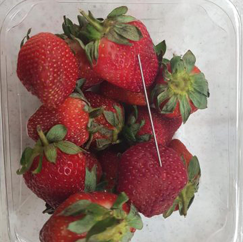 A thin piece of metal seen among a punnet of strawberries. Source: AAP Image/Queensland Police