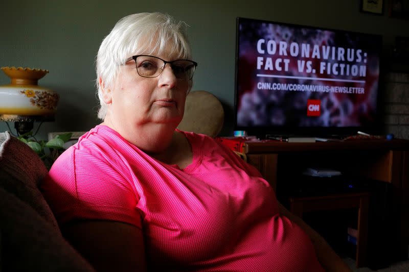 Debbie de los Angeles, whose mother died from coronavirus disease, poses for a portrait at her home in Monroe