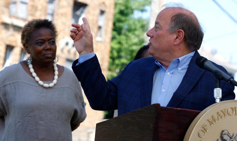 Detroit Mayor Mike Duggan points to and talks about the abandoned apartment complex behind them, as Detroit City Council member Mary Waters looks on, during a press conference on Tyler Street in Detroit on Thursday, July 21, 2022.
Duggan and council members talked about a $203 million affordable housing plan to address housing insecurities in the city.