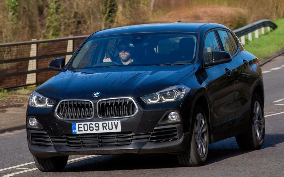 The 2020 BMW X2 in black driving on an English road