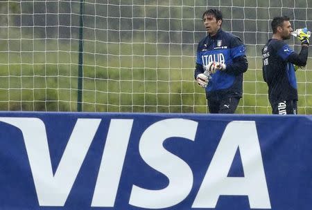 A Visa advertising banner is pictured as Italy's national soccer goalkeepers Gianluigi Buffon and Salvatore Sirigu drink during a training session ahead of the 2014 World Cup at the Portobello training center in Mangaratiba June 10, 2014. REUTERS/Alessandro Garofalo