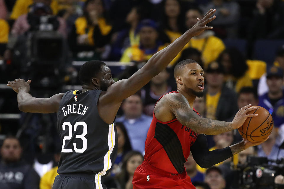 OAKLAND, CALIFORNIA - MAY 16: Draymond Green #23 of the Golden State Warriors defends Damian Lillard #0 of the Portland Trail Blazers in game two of the NBA Western Conference Finals at ORACLE Arena on May 16, 2019 in Oakland, California. NOTE TO USER: User expressly acknowledges and agrees that, by downloading and or using this photograph, User is consenting to the terms and conditions of the Getty Images License Agreement. (Photo by Ezra Shaw/Getty Images)