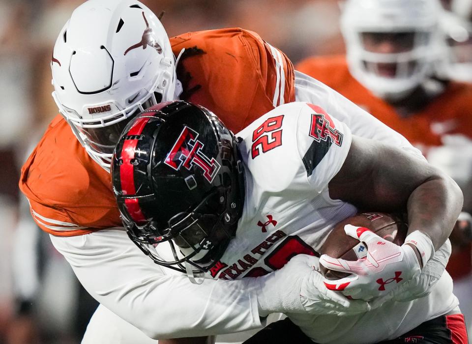Texas defensive tackle T'Vondre Sweat tackles Texas Tech running back Tahj Brooks during the Longhorns' 57-7 win last week. Sweat is fourth on the team in tackles this season.