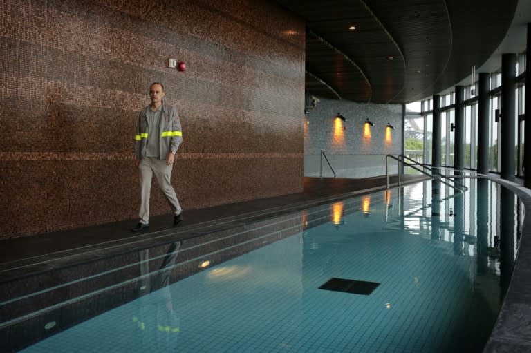 The three mineral-infused pools in the glass-walled spa, each with a different temperature, are powered by the heat from the burning sludge