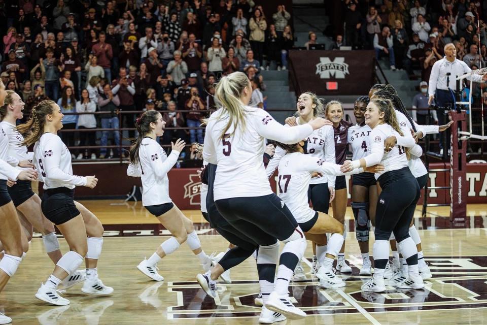 Mississippi State volleyball players celebrate a win against Auburn to close the regular season on Nov. 26, 2021.