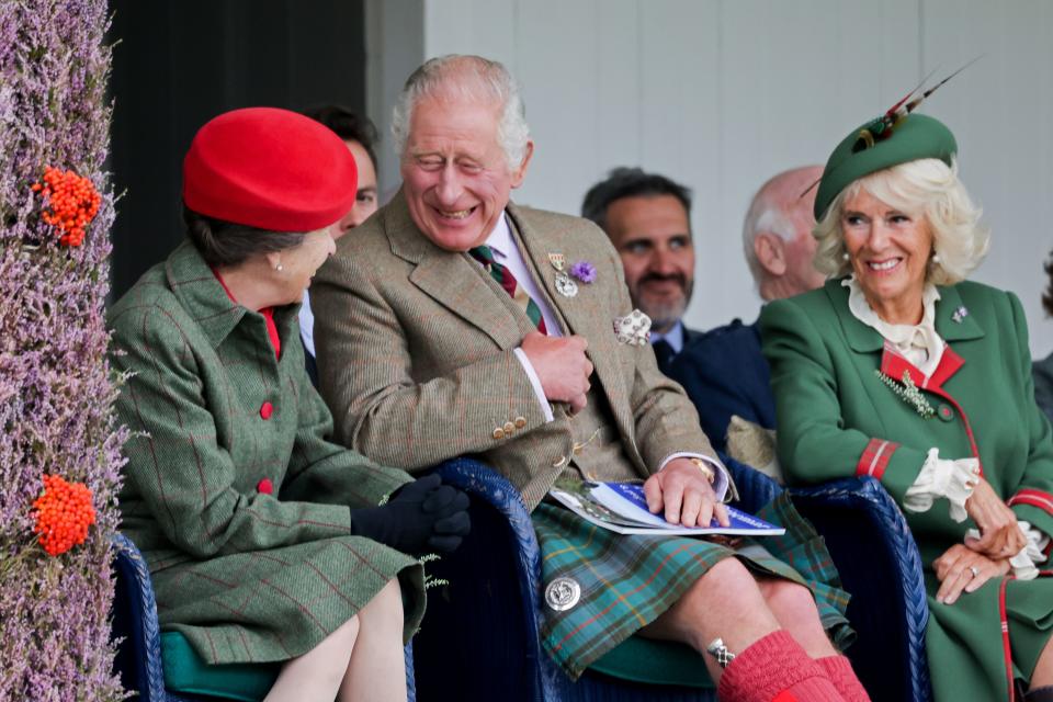 Princess Anne, Prince Charles and Duchess Camilla of Cornwall laughing during the Braemar Gathering Highland Games  on Sept. 3, 2022, in Braemar, Scotland.