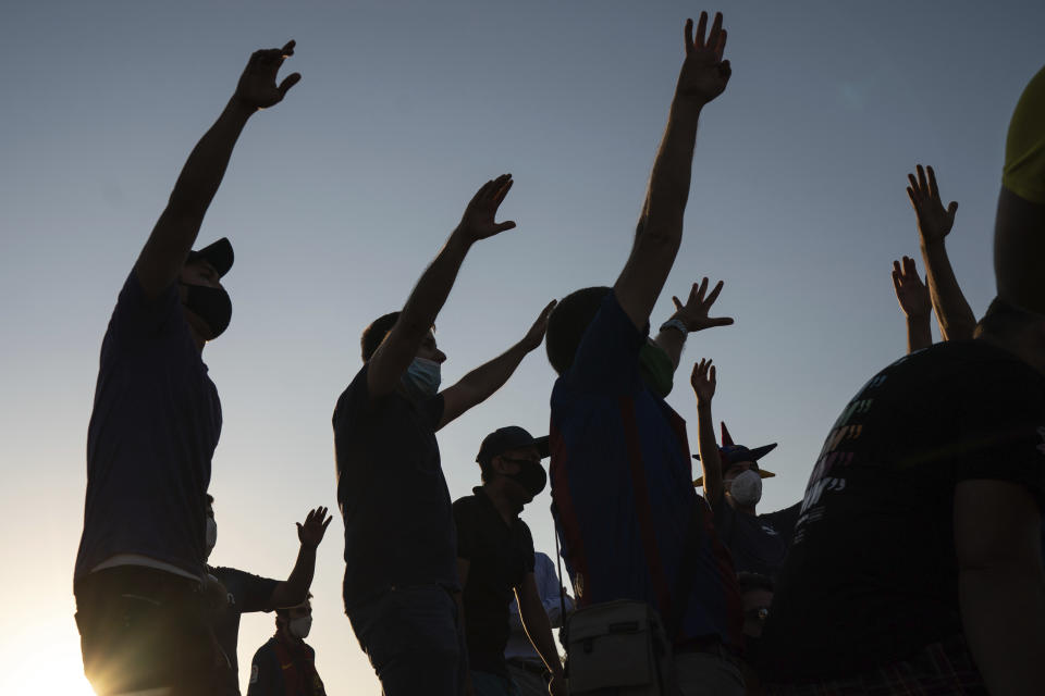 Barcelona fans chant slogans during a protest against the club's president Josep Maria Bartomeu, outside the Camp Nou stadium in Barcelona, Spain, Wednesday, Aug. 26, 2020. Lionel Messi has told Barcelona he wants to leave the club after nearly two decades with the Spanish giants. The club has confirmed that the Argentina great has sent a note expressing his desire to leave. (AP Photo/Felipe Dana)