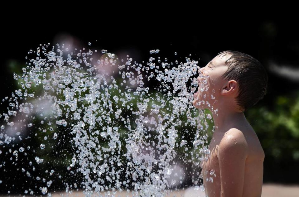 Gavin Toscno, 6, of Rancho Cordova, cools down in a water fountain at Village Green Park on Thursday, July 11, 2024, in Rancho Cordova.