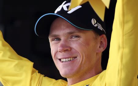 Team Sky rider Chris Froome of Britain wears the race leader's yellow jersey on the podium after the 188-km (116.8 miles) 11th stage of the 102nd Tour de France cycling race from Pau to Cauterets in the French Pyrenees mountains, France, July 15, 2015. REUTERS/Stefano Rellandini