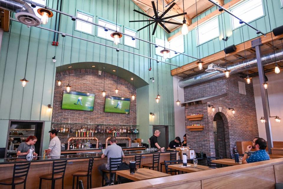 High, airy ceilings lined with windows allow natural light into the new Mad Duck location at Maple and Copper where their signature archways and brick accents give a welcoming vibe in the dining room and bar built from the ground up. CRAIG KOHLRUSS/ckohlruss@fresnobee.com