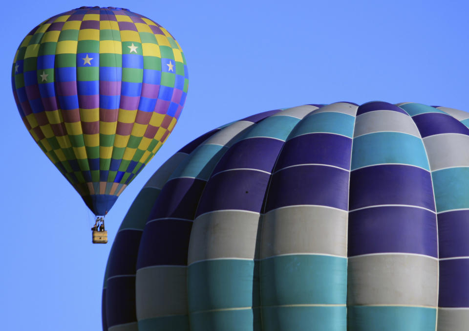 Hot air balloons participating in the Albuquerque International Balloon Fiesta on Tuesday, Oct. 10, 2017. (AP Photo/Susan Montoya Bryan)