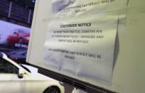 An information sign related to the current outbreak of fuel panic buying is seen at a petrol station in Manchester, England, Monday, Sept. 27, 2021. British Prime Minister Boris Johnson is said to be considering whether to call in the army to deliver fuel to petrol stations as pumps ran dry after days of panic buying. ( AP Photo/Jon Super)