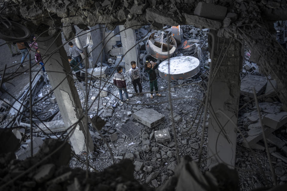 Palestinians look at the destruction after an Israeli strike in Rafah, southern Gaza Strip, Wednesday, Jan. 3, 2024. (AP Photo/Fatima Shbair)