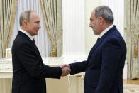 Russian President Vladimir Putin, right, greets Armenian Prime Minister Nikol Pashinyan prior to their talks in the Kremlin in Moscow, Russia, Monday, Jan. 11, 2021. Putin hosted the leaders of Armenia and Azerbaijan for talks after six weeks of fierce fighting over Nagorno-Karabakh that ended with a Russia-brokered peace deal in November. (Mikhail Klimentyev, Sputnik, Kremlin Pool Photo via AP)