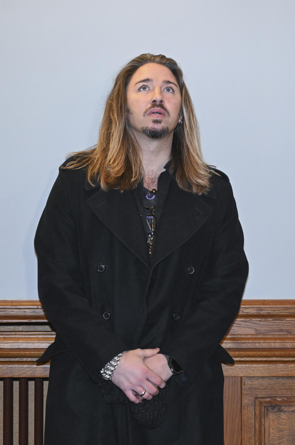 German rock musician Gil Ofarim stands in the courtroom of the district court in Leipzig, Germany, Tuesday, Nov. 28, 2023. A German-Israeli singer who claimed he had been turned away from a hotel in the eastern German city of Leipzig because he was wearing a Star of David pendant, admitted during a defamation trial against him over the incident on Tuesday that he had made up the story. (Hendrik Schmidt/dpa via AP)