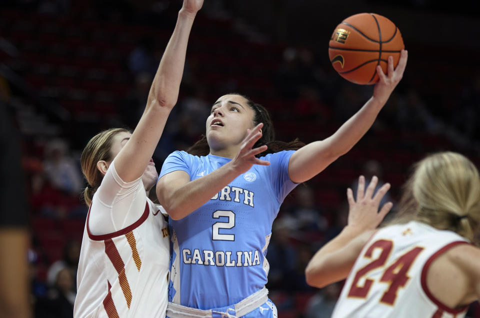 North Carolina guard Paulina Paris, cneter, shoots over Iowa State forward Morgan Kane during the first half of an NCAA college basketball game in the Phil Knight Invitational in Portland, Ore., Sunday, Nov. 27, 2022. (AP Photo/Craig Mitchelldyer)