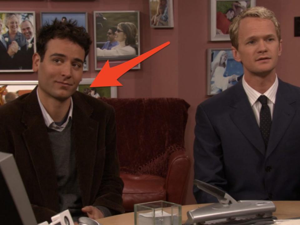 arrow pointing to ted sitting next to barney in an office on an episode of how i met your mother