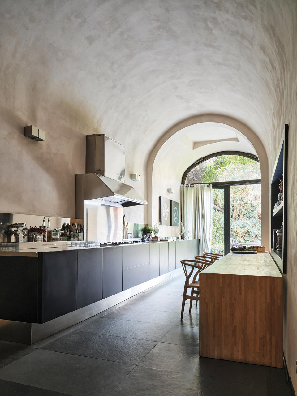 The owners paired a custom beechwood kitchen table with a trio of Carl Hansen Wishbone chairs.