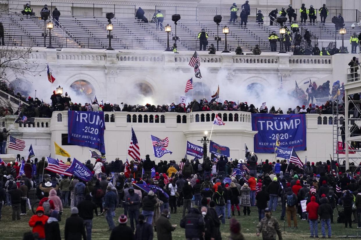 <span class="caption">Rioters storm the U.S. Capitol on Jan. 6, 2021, seeking to intimidate politicians into overturning the presidential election.</span> <span class="attribution"><a class="link " href="https://newsroom.ap.org/detail/TrumpImpeachmentRioters/618074307ba64a4f9c883b7d26fa5242/photo" rel="nofollow noopener" target="_blank" data-ylk="slk:AP Photo/John Minchillo;elm:context_link;itc:0;sec:content-canvas">AP Photo/John Minchillo</a></span>