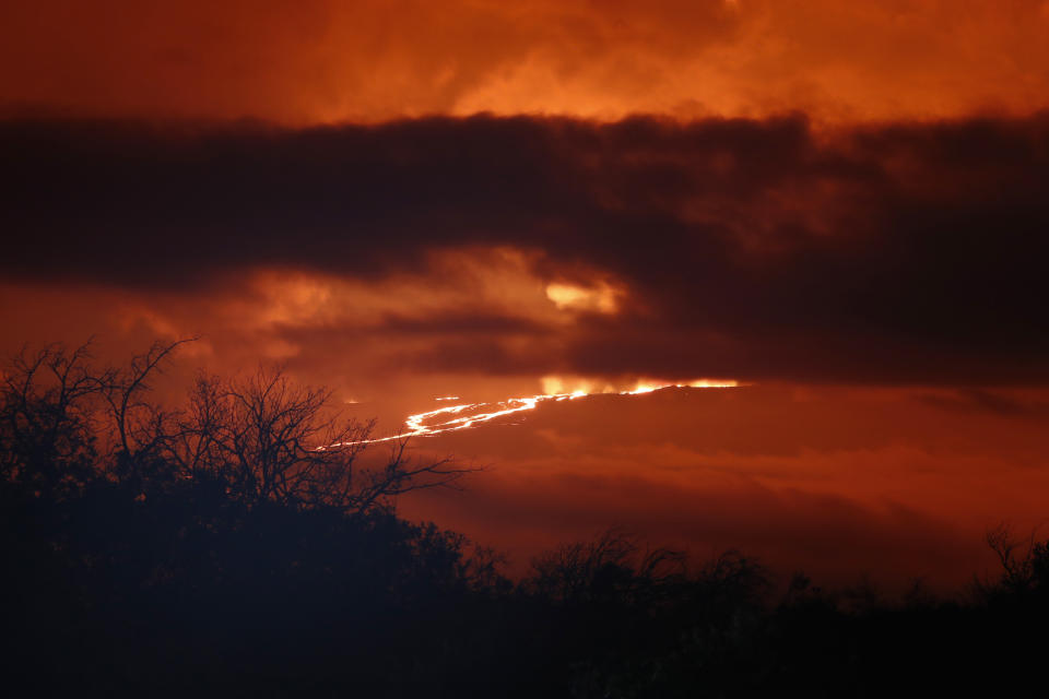 A river of lava flows down from Mauna Loa, Monday, Nov. 28, 2022, near Hilo, Hawaii. Mauna Loa, the world's largest active volcano erupted Monday for the first time in 38 years. (AP Photo/Marco Garcia)