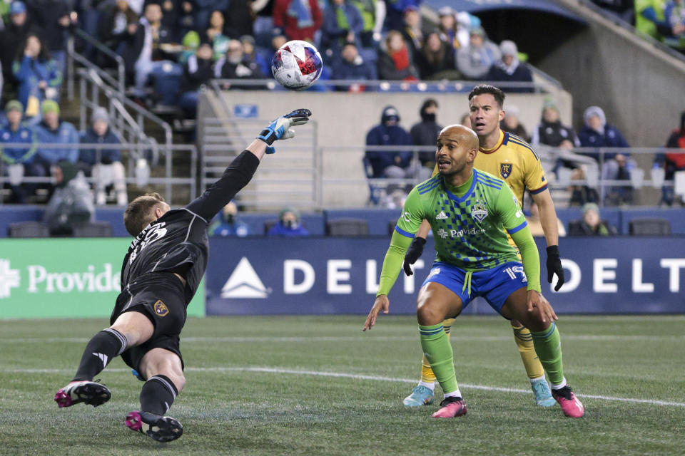 Real Salt Lake goalkeeper Zac MacMath, left, makes a save against Seattle Sounders forward Heber during the second half of an MLS soccer match Saturday, March 4, 2023, in Seattle. The Sounders won 2-0. (AP Photo/Jason Redmond)