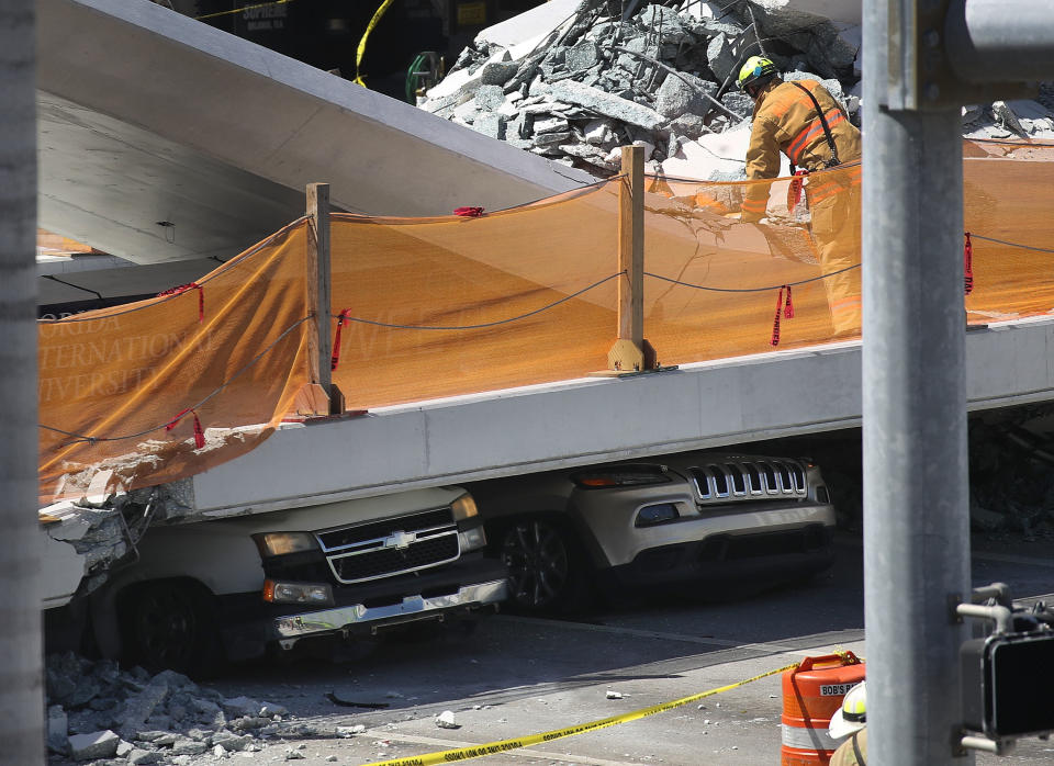 Vehicles are trapped under the collapsed pedestrian bridge&nbsp;on March 15. (Photo: Joe Raedle via Getty Images)