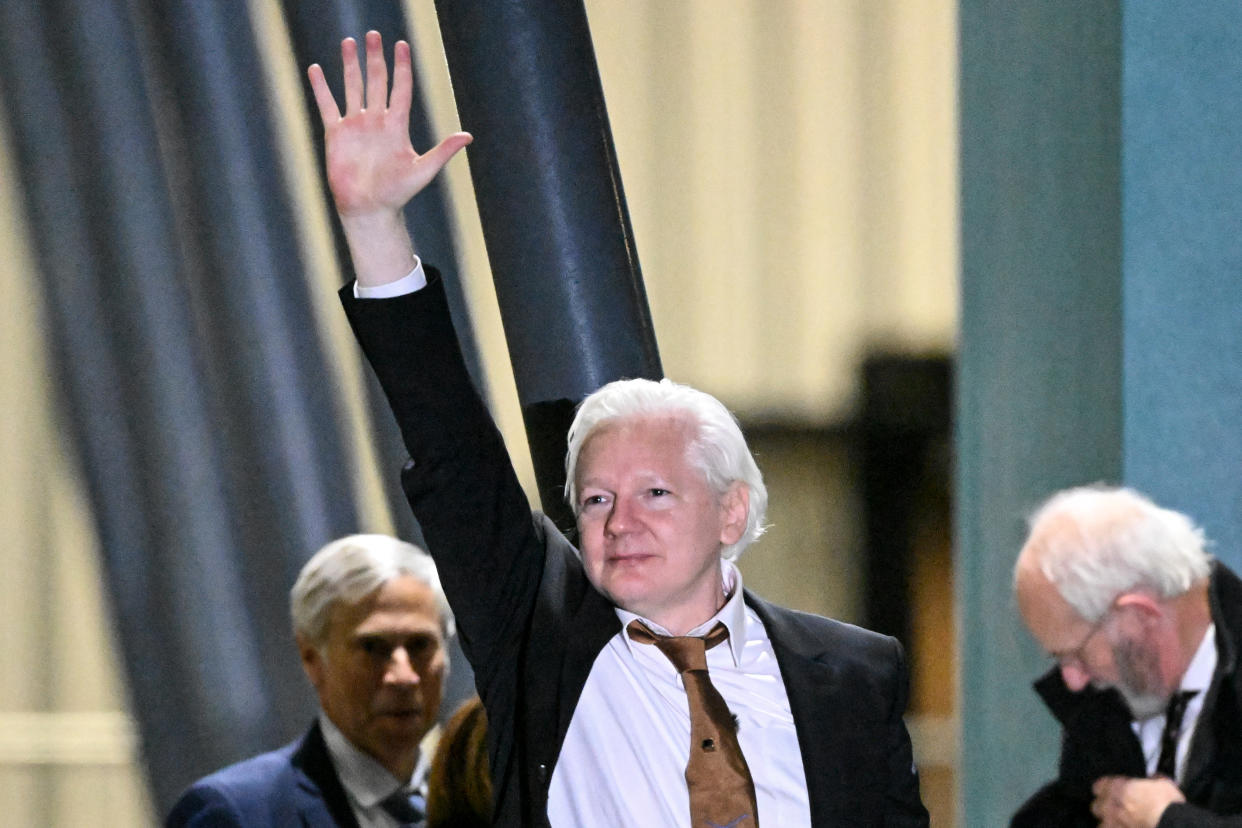 WikiLeaks founder Julian Assange waves after arriving at Canberra Airport in Canberra on June 26, 2024. (Getty)