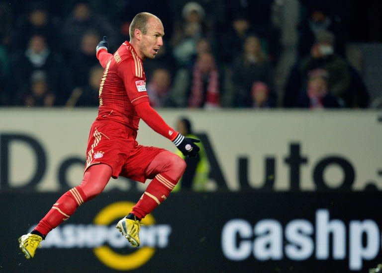 Bayern Munich's Dutch midfielder Arjen Robben scores during the German first division Bundesliga football match against Wolfsburg on February 15, 2013. Robben has admitted he is unhappy with his place on the bench as Bayern prepare for Tuesday's trip to Arsenal by extending their Bundesliga unbeaten run to 18 matches with victory at Wolfsburg