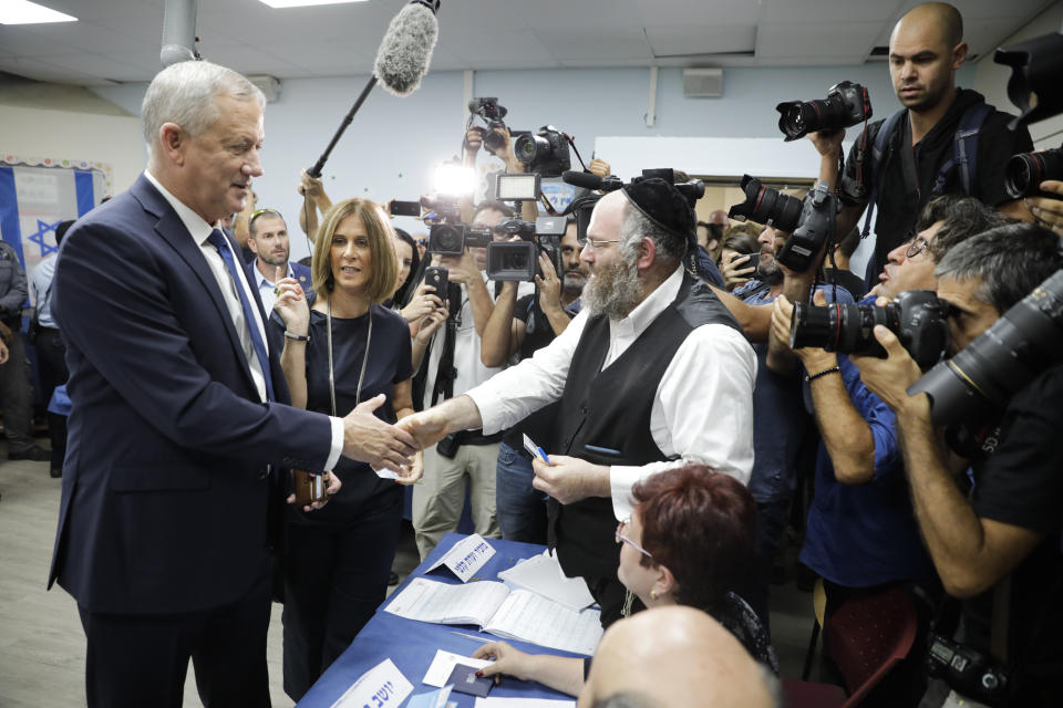 Blue and White party leader Benny Gantz and his wife Revital vote in Rosh Haayin, Israel, Tuesday, Sept. 17, 2019. Israelis began voting Tuesday in an unprecedented repeat election that will decide whether longtime Prime Minister Benjamin Netanyahu stays in power despite a looming indictment on corruption charges. (AP Photo/Sebastian Scheiner)