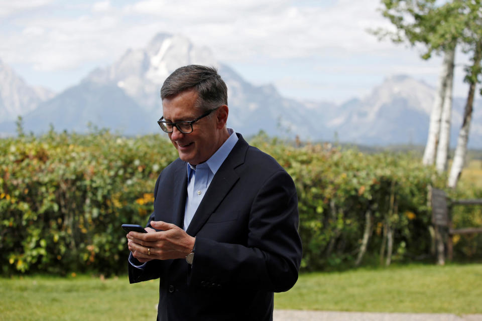 Federal Reserve Vice Chair Richard Clarida reacts as he holds his phone during the three-day 