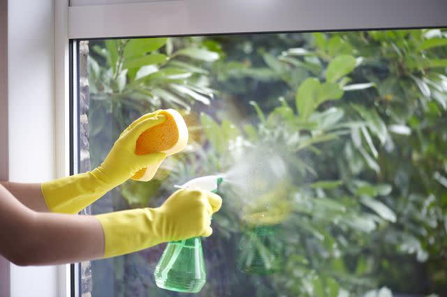 Howard Shooter/Dorling Kindersley/Getty Images Woman Cleaning a Window with Vinegar