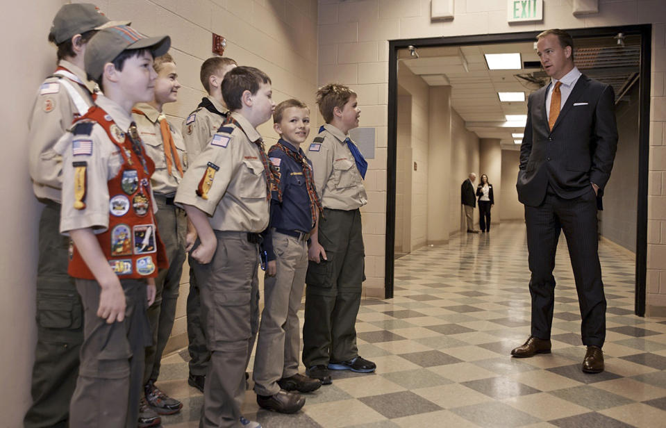 This Wednesday, April 16, 2014 photo provided by the Boy Scouts of America shows Peyton Manning talking to a group of scouts before he spoke to the Boy Scouts of America's annual breakfast in Denver. It was his first public comments since the Denver Broncos were trounced by Seattle from the opening snap of the Super Bowl. (AP Photo/Boy Scouts of America, Dan Sidor)