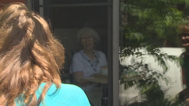 Mary House-Goldman visiting her mother Patricia Janes, 85, through the window of a long-term care home in Toronto on July 1, 2020.  (CBC - image credit)