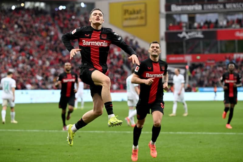 Leverkusen's Florian Wirtz (L) celebrates scoring his side's third goal during the German Bundesliga soccer match between Bayer 04 Leverkusen and SV Werder Bremen at BayArena. Federico Gambarini/dpa