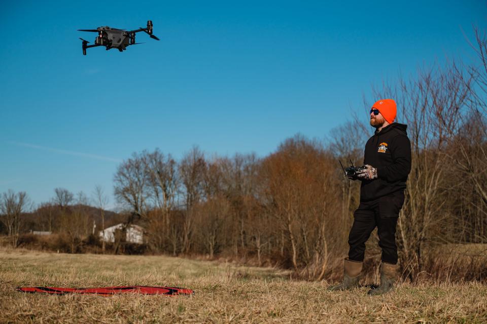 A hunter launches his drone, a DJI Matrice 30T, during a flight demonstration.