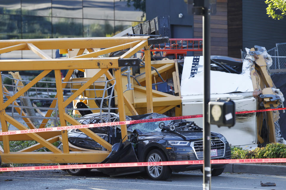 Emergency crews work at the scene of a construction crane collapse where several people were killed and others were injured Saturday, April 27, 2019, in the South Lake Union neighborhood of Seattle. The crane collapsed near the intersection of Mercer Street and Fairview Avenue pinning cars underneath it near Interstate 5. (AP Photo/Joe Nicholson)