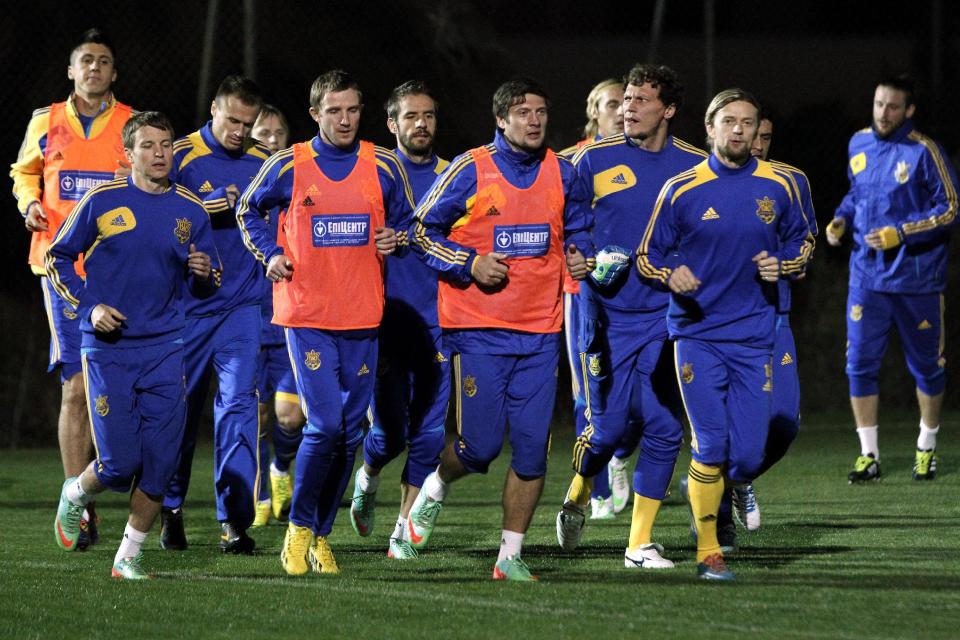 Ukrainian national soccer team players warm up during a training session at the Ayia Napa resort, southeastern Cyprus, Thursday, March 4, 2014. Ukraine will face the United States in a friendly soccer match on Wednesday in Cyprus, after the match was moved from Kharkiv, Ukraine to Larnaca for security reasons. (AP Photo/Petros Karadjias)