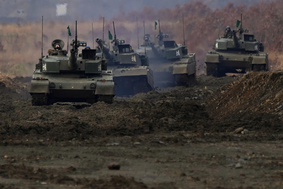 Japanese Ground-Self Defense Force (JGDDF) Type 90 tanks maneuver through a course during an annual exercise at the Minami Eniwa Camp Tuesday, Dec. 7, 2021, in Eniwa, Japan's northern island of Hokkaido. Dozens of tanks are rolling over the next two weeks on Hokkaido, a main military stronghold for a country with perhaps the world's most little known yet powerful army. (AP Photo/Eugene Hoshiko)