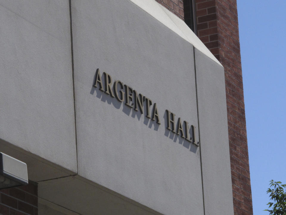 Signage for the dormitory at Argenta Hall is displayed at the University of Nevada, Reno, Thursday, July 11, 2019. A July 5 natural gas explosion blew out walls and windows in the mostly empty dormitory and one next door. School officials gave members of the media their first up-close look at the exterior and interior damage on Thursday. (AP Photo/Scott Sonner)