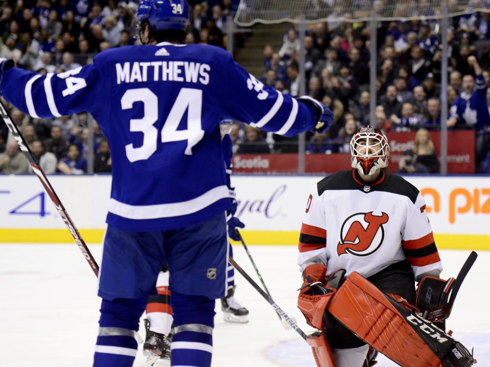 New Jersey Devils goaltender Louis Domingue (70) reacts after giving up a goal to Toronto Maple Leafs center Auston Matthews (34) during the second period of an NHL hockey game Tuesday, Jan. 14, 2020, in Toronto. (Frank Gunn/The Canadian Press via AP)