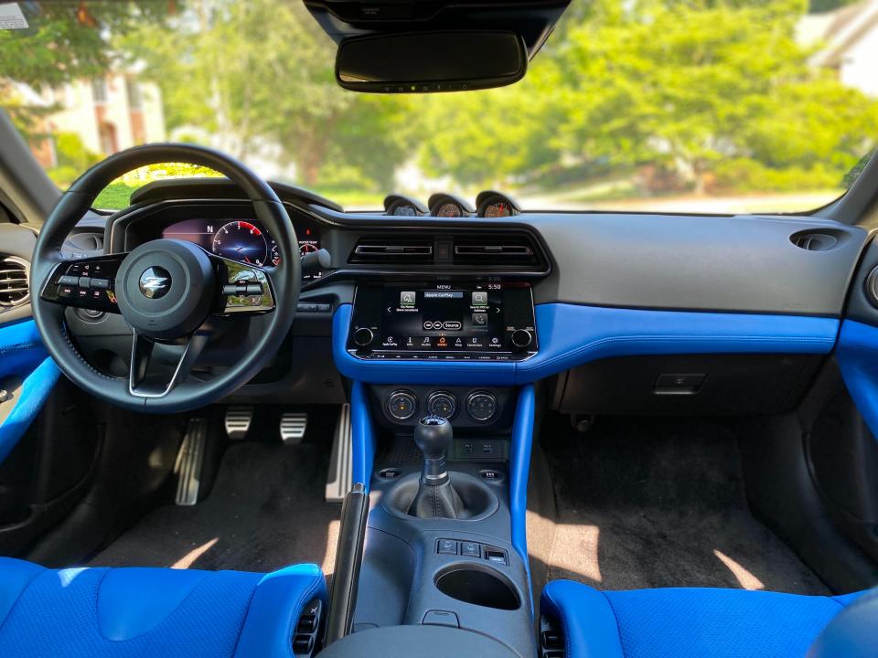 The blue and black front dash of a 2024 Nissan Z sports car.