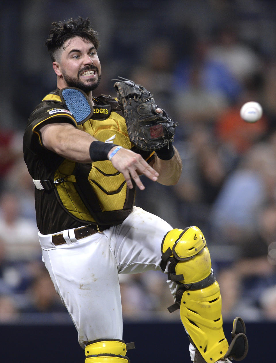 San Diego Padres catcher Austin Hedges throws to first base late on a wild pitch swinging strike-out by San Francisco Giants' Austin Slater during the sixth inning of a baseball game Friday, July 26, 2019, in San Diego. (AP Photo/Orlando Ramirez)