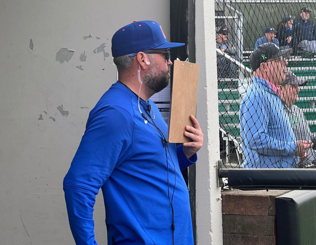 Olentangy Orange pitching coach Zane Bayliss relays strategy to catcher Casey Covert during a game at Dublin Coffman on April 9.